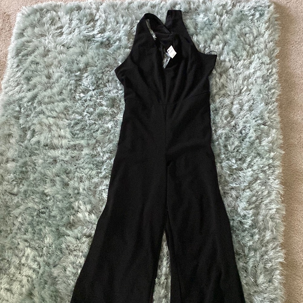 Black jumpsuit. Wide leg open criss cross back.
